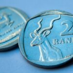 Rand hits up – but stays on the back foot