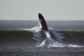 Cigarette boat takes on a huge surf and it doesn’t