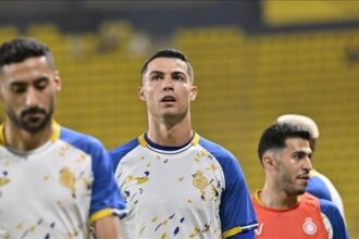 Cristiano Ronaldo falls to the ground after scoring a goal