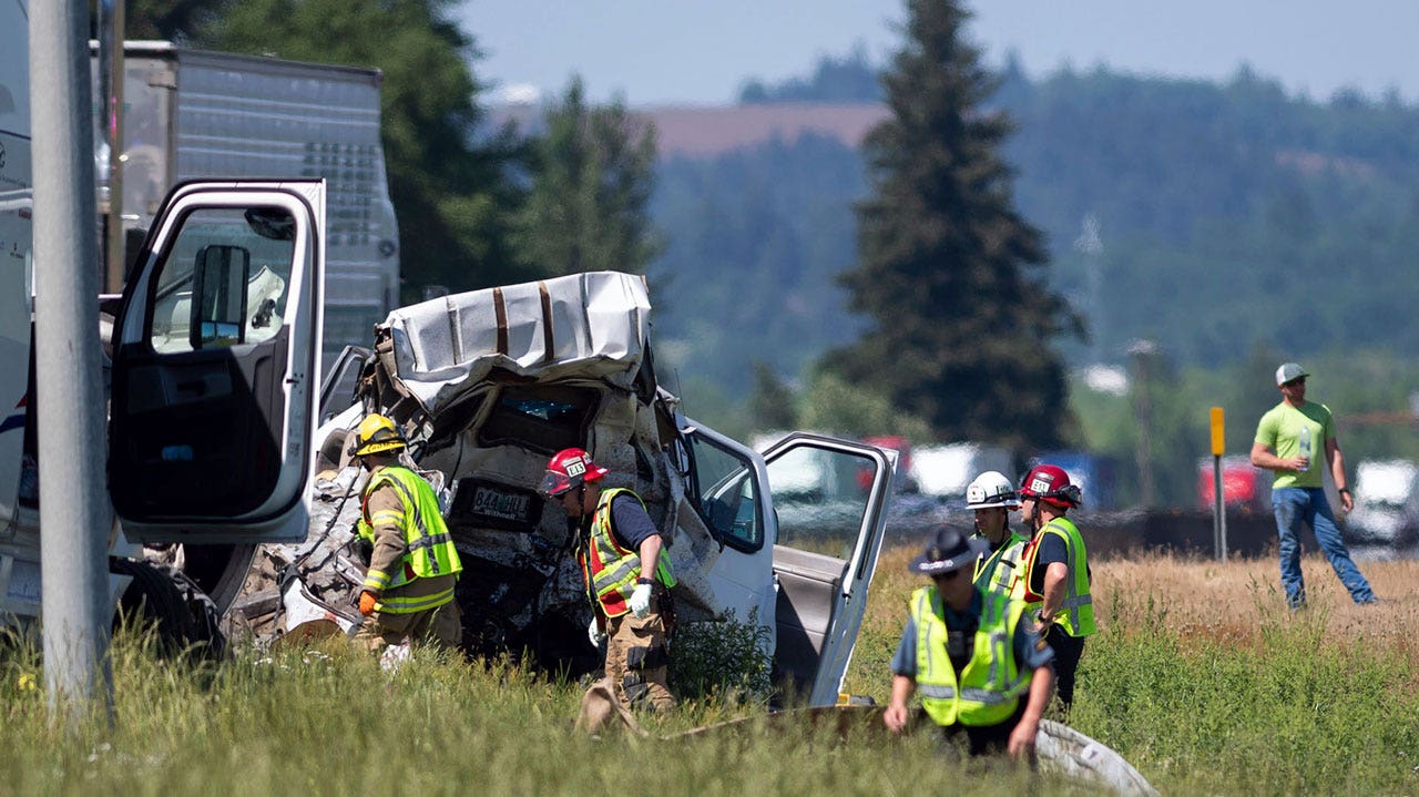 Truck driver stopped on highway with several vehicles